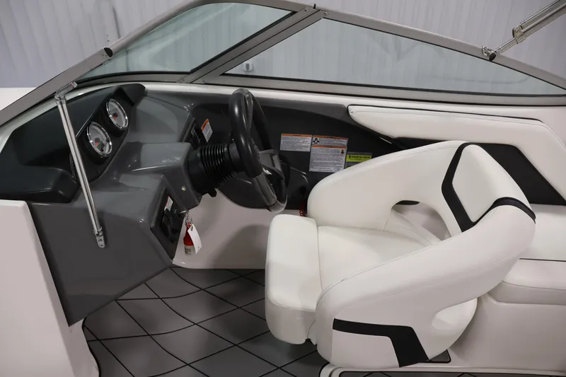 Slide: The Image of 2016 Yamaha Boats SX190 interior with steering wheel and white seating. - 12