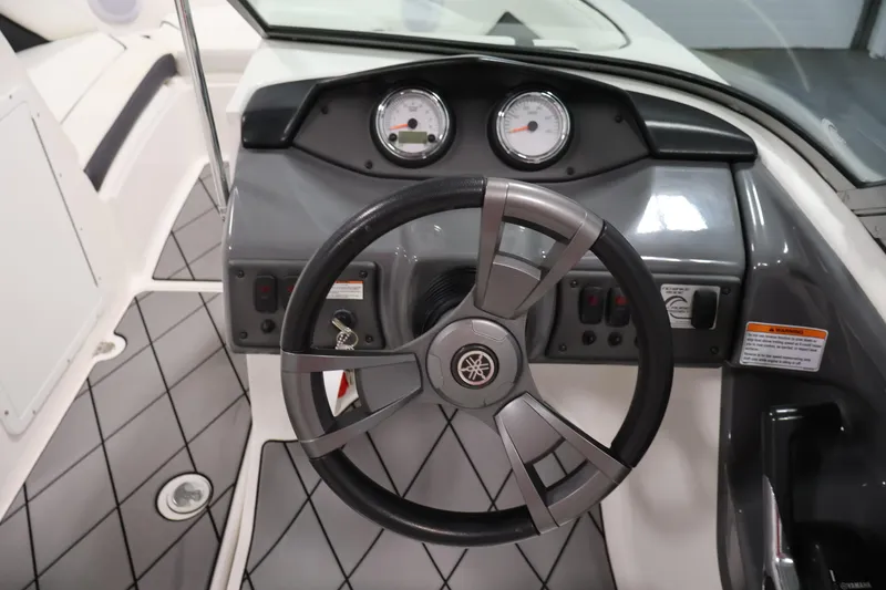 Slide: The Image of 2016 Yamaha Boats SX190 dashboard with steering wheel and gauges. - 13