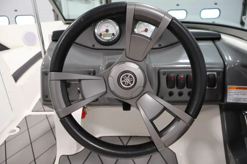 Slide: The Image of Steering wheel of 2016 Yamaha Boats SX190, featuring dashboard controls and gauges. - 14