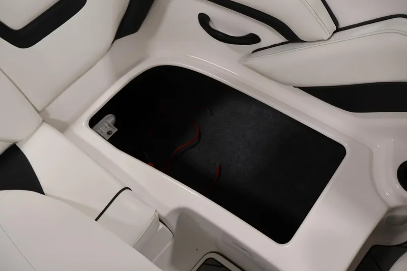 Slide: The Image of 2016 Yamaha SX190 boat interior storage compartment with white seating. - 29