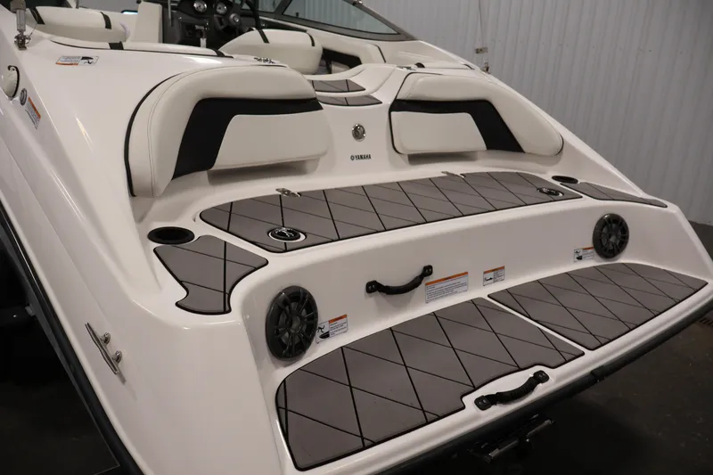Slide: The Image of 2016 Yamaha Boats SX190, rear view with cushioned seating and deck details. - 33