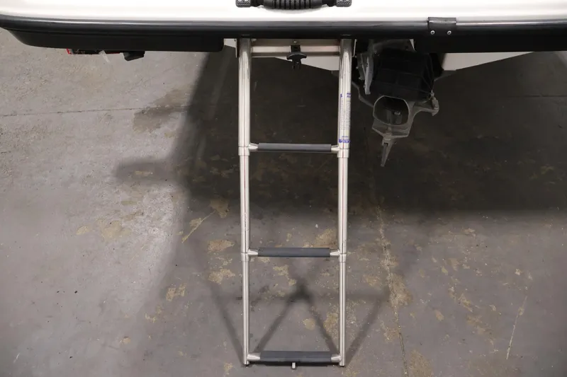 Slide: The Image of 2016 Yamaha Boats SX190 with extended swim ladder on concrete floor. - 34