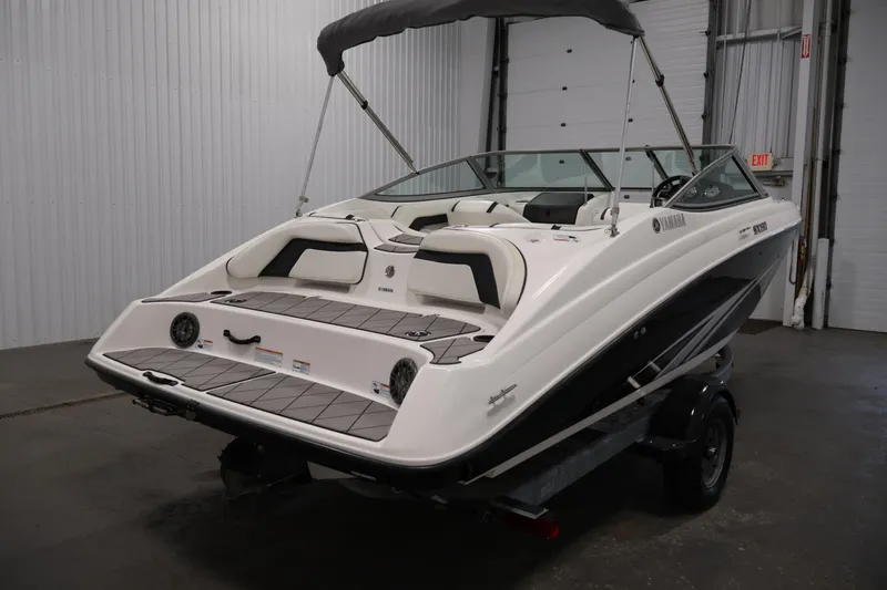 Slide: The Image of 2016 Yamaha Boats SX190 in a garage, showcasing sleek design and spacious seating. - 4