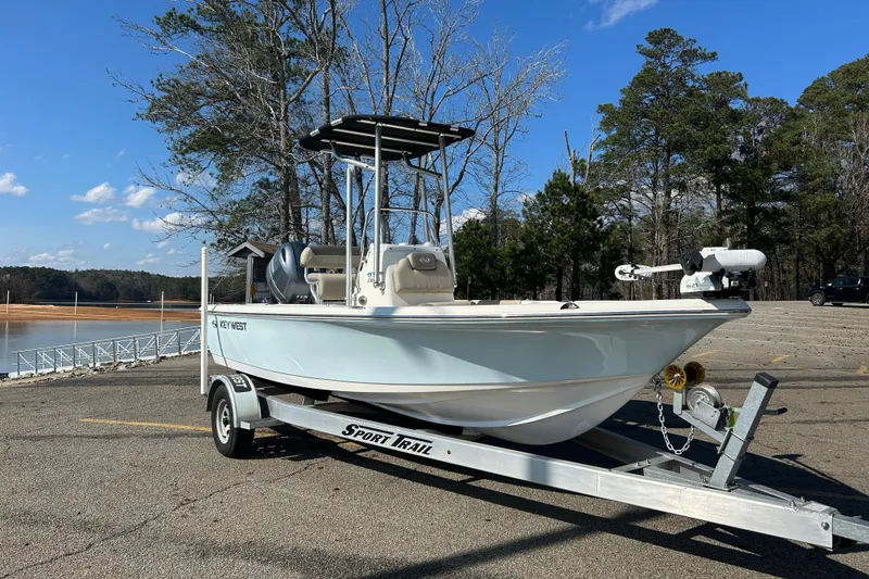 Slide: The Image of 2021 Key West 188 Bay Reef boat on trailer, parked outdoors. - 1