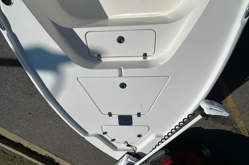 Slide: The Image of 2021 Key West 188 Bay Reef boat with seating and console, parked outdoors. - 11