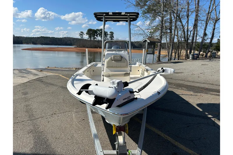 Slide: The Image of 2021 Key West 188 Bay Reef boat on trailer by a lake under blue sky. - 5