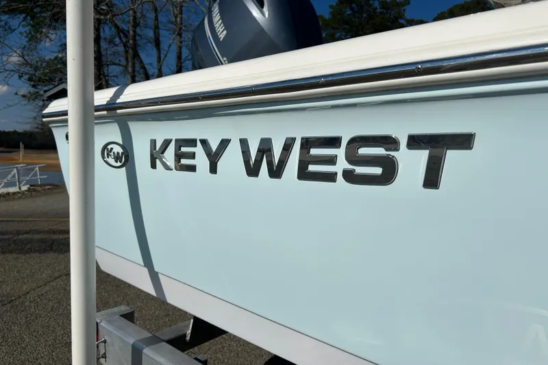 Slide: The Image of 2021 Key West 188 Bay Reef boat console with steering wheel and navigation controls. - 7