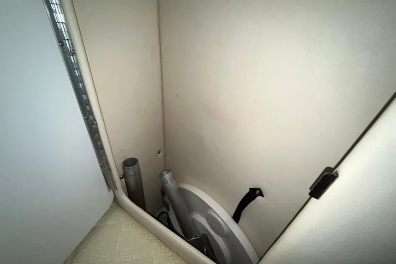 Slide: The Image of 2004 Sea Ray Sundancer 260 interior storage compartment with pipes and fittings. - 12