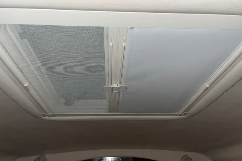 Slide: The Image of 2004 Sea Ray Sundancer 260 cabin skylight with screen and shade. - 18