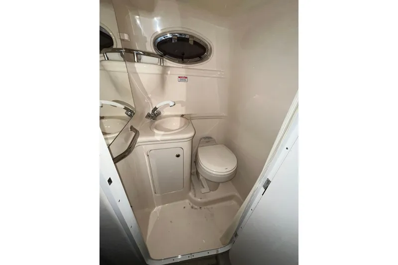 Slide: The Image of 2004 Sea Ray Sundancer 260 boat bathroom with sink and toilet. - 23