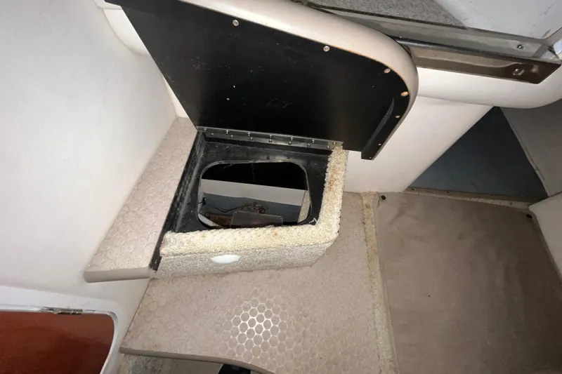 Slide: The Image of Open storage compartment in 2004 Sea Ray Sundancer 260 boat interior. - 28