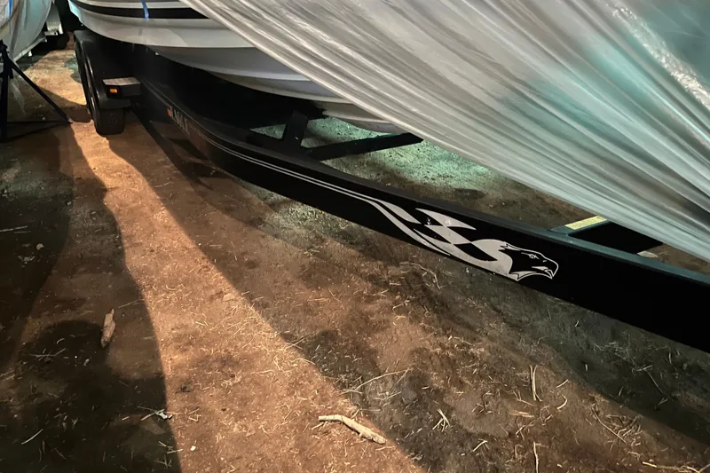 Slide: The Image of 2004 Sea Ray Sundancer 260 boat on trailer, partially covered, in storage. - 32