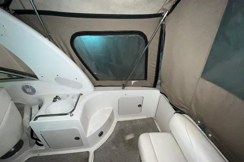 Slide: The Image of 2004 Sea Ray Sundancer 260 interior with sink, seating, and window. - 4