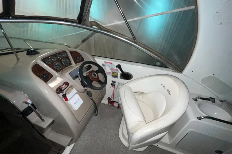 Slide: The Image of 2004 Sea Ray Sundancer 260 helm with steering wheel and control panel. - 7