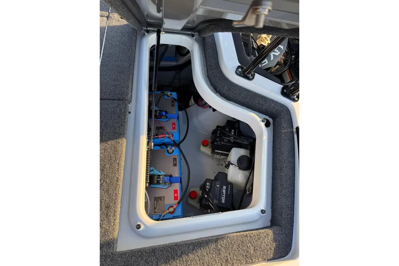 Slide: The Image of 2024 Ikon Boats 21 model battery compartment with wiring and components. - 11
