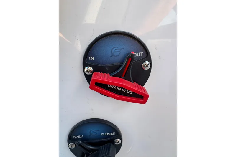 Slide: The Image of 2024 Ikon Boats 21 drain plug with red handle, labeled "IN" and "OUT." - 12