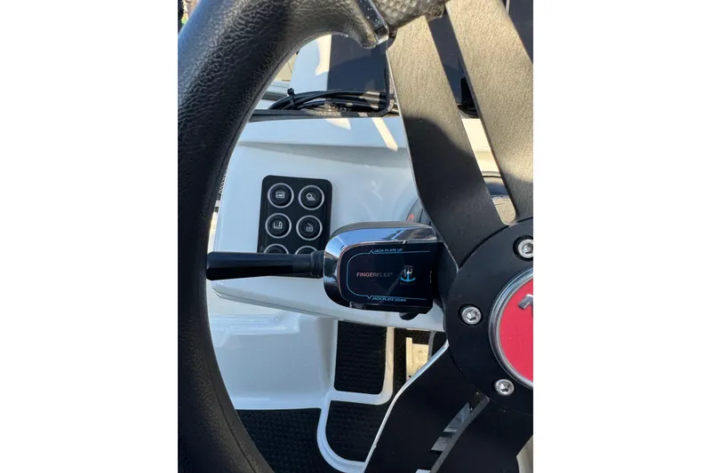 Slide: The Image of Steering wheel and controls of 2024 Ikon Boats 21 model. - 13