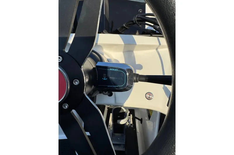 Slide: The Image of Steering wheel and controls of 2024 Ikon Boats 21 model. - 14