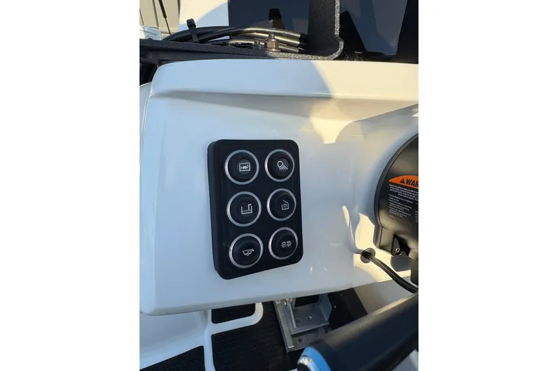 Slide: The Image of Control panel on 2024 Ikon Boats 21, featuring six circular buttons. - 15