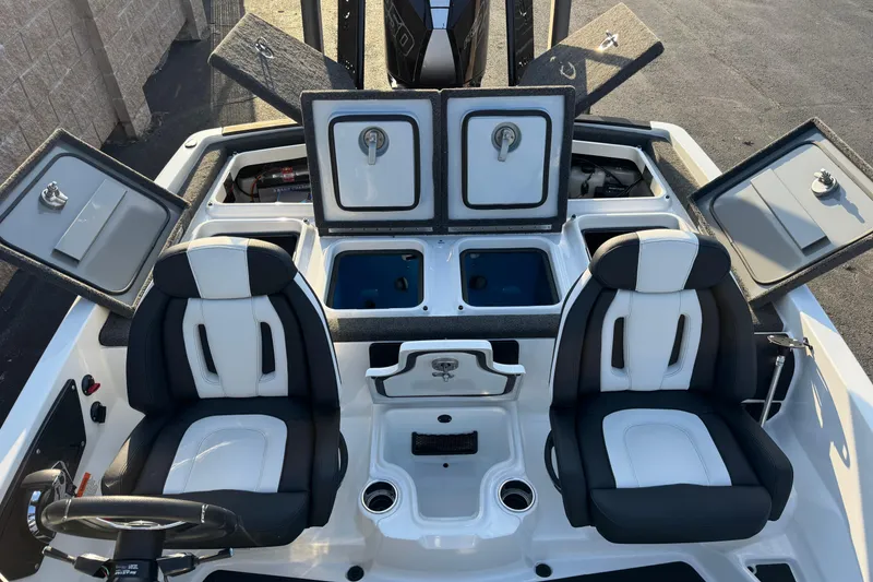 Slide: The Image of 2024 Ikon Boats 21 interior with dual seats, storage compartments, and steering wheel. - 20