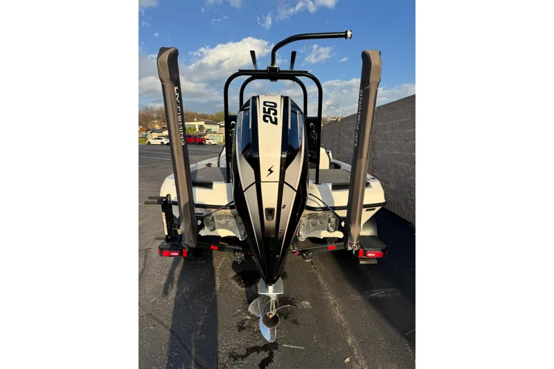 Slide: The Image of 2024 Ikon Boats 21 with powerful 250 engine, parked outdoors under blue sky. - 3