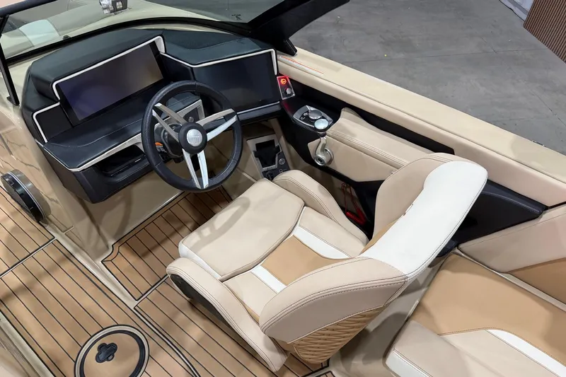 Slide: The Image of 2025 MasterCraft X24 boat interior with modern dashboard and beige seating. - 22