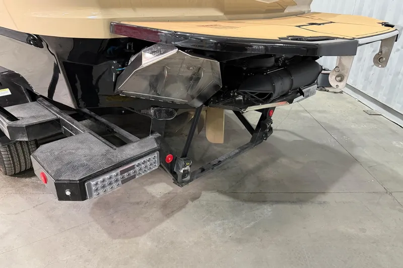 Slide: The Image of 2025 MasterCraft X24 boat trailer with detailed rear view in a garage setting. - 27