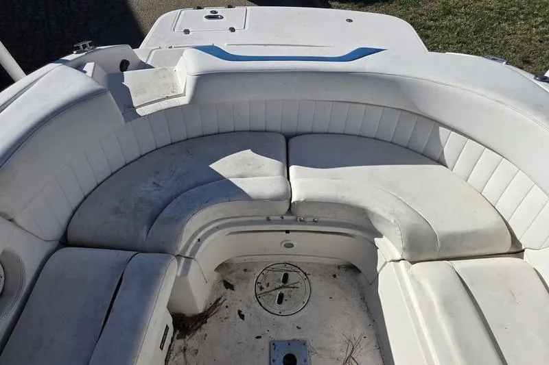 Slide: The Image of 2005 Regal 2400 Bowrider boat interior with white seating and storage compartments. - 10