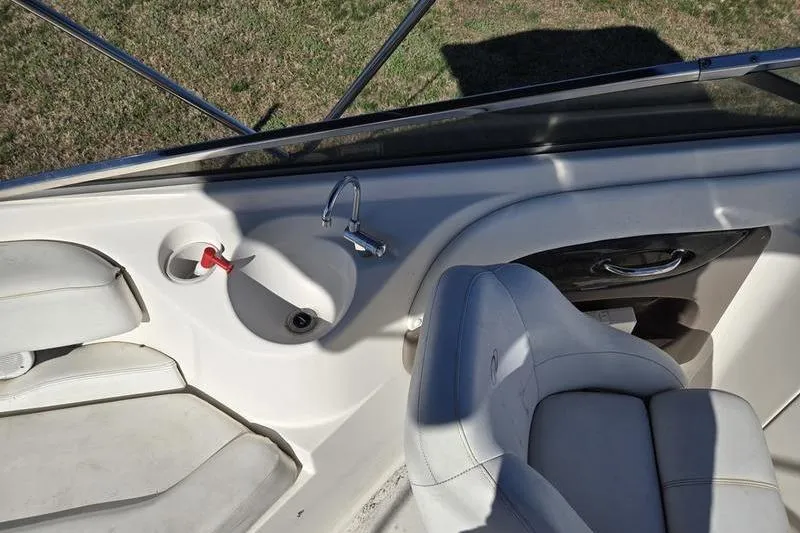 Slide: The Image of 2005 Regal 2400 Bowrider interior with seating and built-in sink. - 11