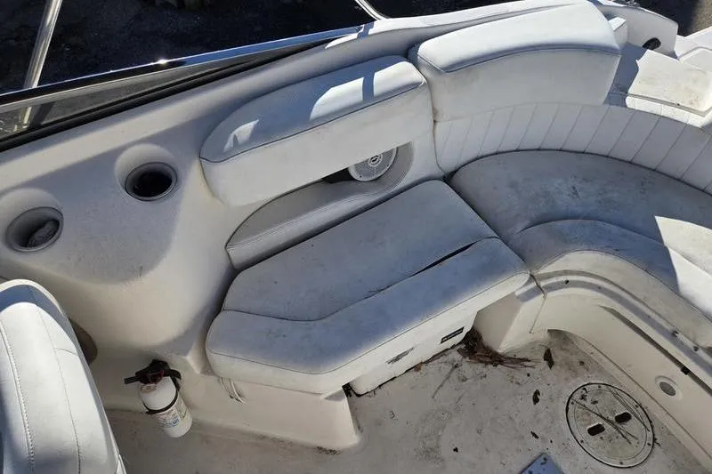 Slide: The Image of 2005 Regal 2400 Bowrider interior with white seating and cup holders. - 12