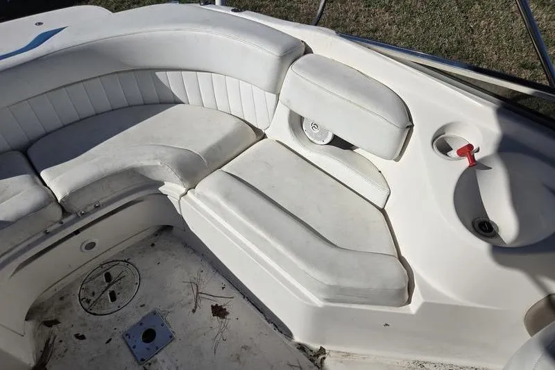 Slide: The Image of 2005 Regal 2400 Bowrider interior with white seating and cup holder. - 13