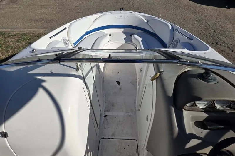 Slide: The Image of 2005 Regal 2400 Bowrider boat interior with seating and dashboard view. - 15