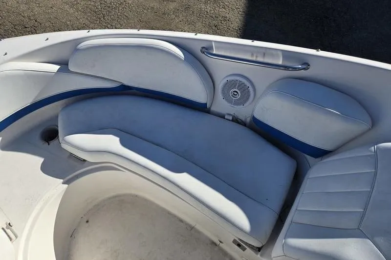Slide: The Image of 2005 Regal 2400 Bowrider boat interior with white seating and speaker. - 17