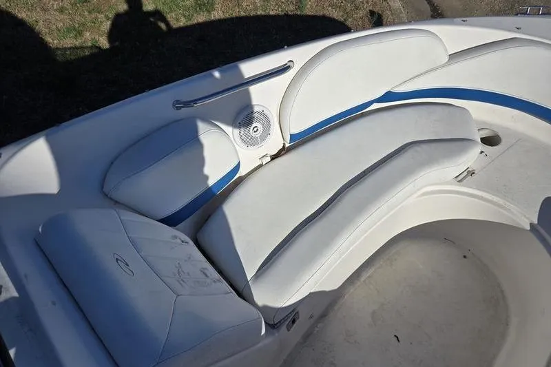 Slide: The Image of 2005 Regal 2400 Bowrider boat interior with white and blue seating. - 18