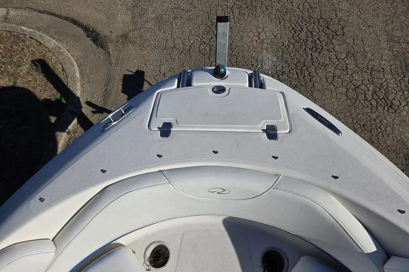 Slide: The Image of 2005 Regal 2400 Bowrider boat bow view with seating and storage compartment. - 2