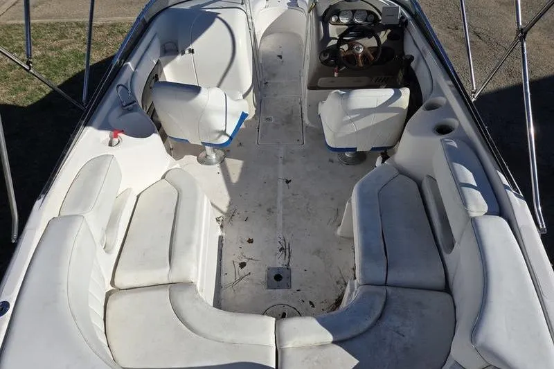 Slide: The Image of 2005 Regal 2400 Bowrider interior with white seating and steering console. - 3