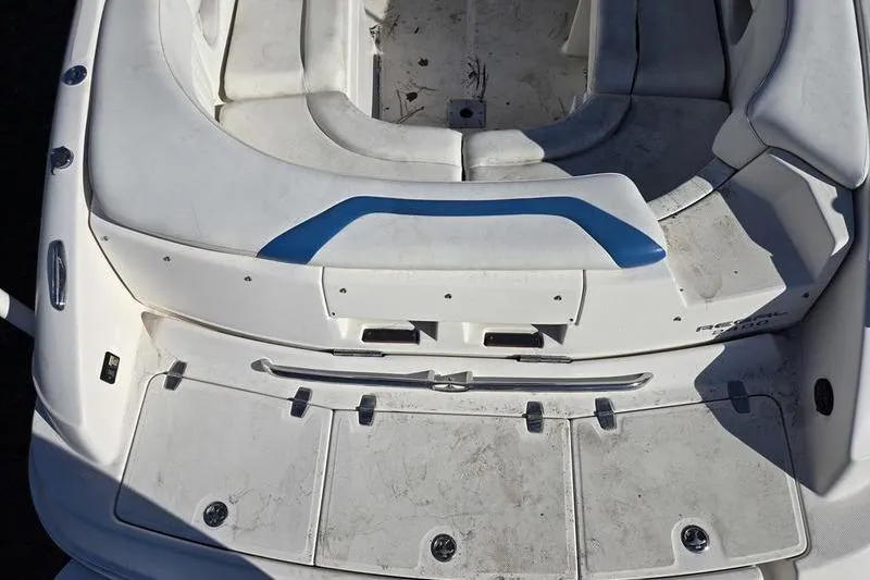 Slide: The Image of 2005 Regal 2400 Bowrider boat interior with white seating and blue accents. - 5