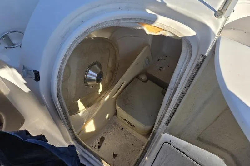 Slide: The Image of 2005 Regal 2400 Bowrider boat interior with storage compartment and portable toilet. - 8