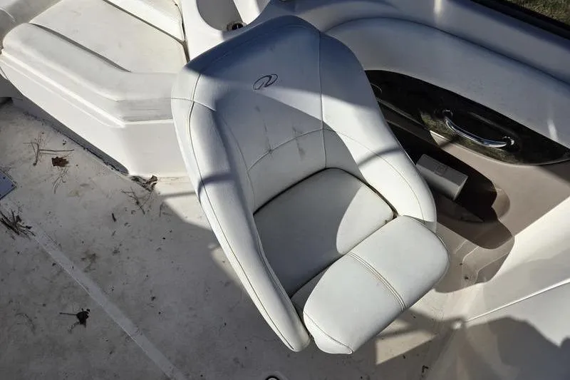 Slide: The Image of 2005 Regal 2400 Bowrider boat seat, white upholstery, clean and well-maintained. - 9