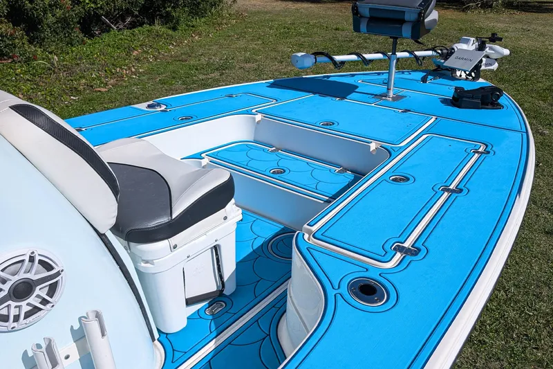 Slide: The Image of 2023 ShearWater X22 Hybrid boat with blue deck and seating, featuring advanced equipment. - 12