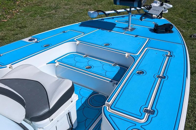 Slide: The Image of 2023 ShearWater X22 Hybrid boat with blue deck and seating, featuring advanced equipment. - 13