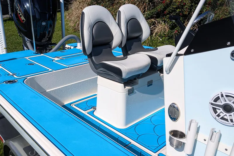 Slide: The Image of 2023 ShearWater X22 Hybrid boat interior with blue deck and dual seats. - 15