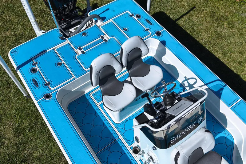 Slide: The Image of 2023 ShearWater X22 Hybrid boat interior with blue deck and dual seats. - 25