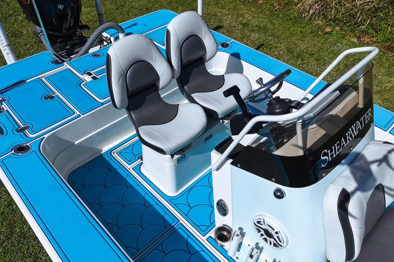 Slide: The Image of 2023 ShearWater X22 Hybrid boat interior with dual seats and steering console. - 26