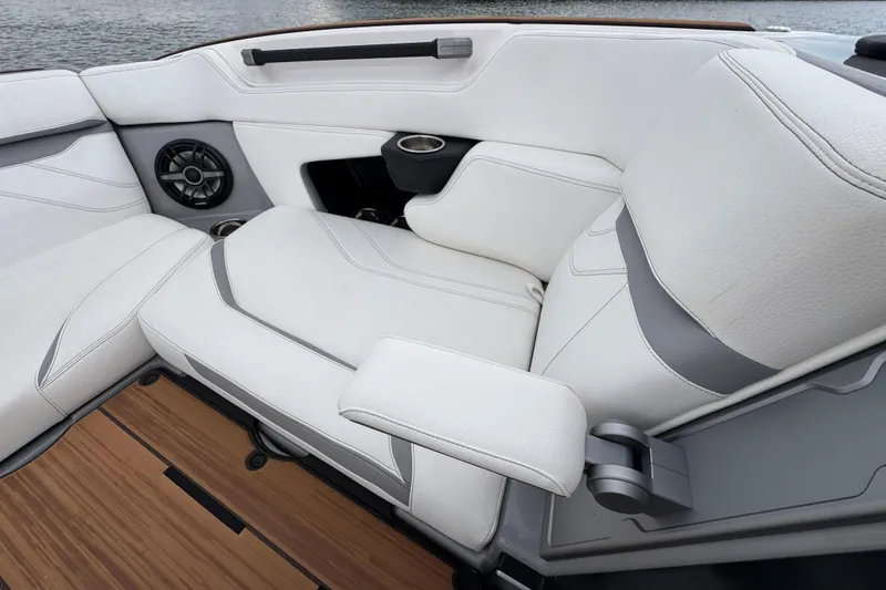 Slide: The Image of Luxurious seating in 2023 Supra SE 550 boat with white upholstery and speaker system. - 10