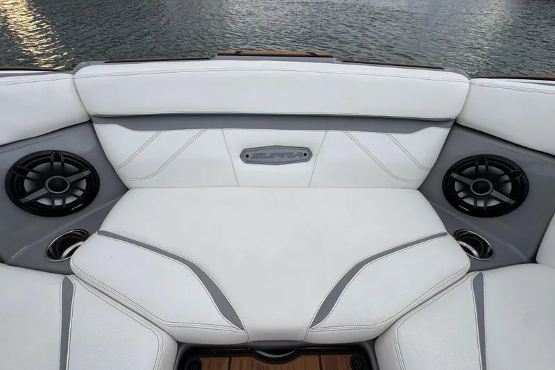 Slide: The Image of 2023 Supra SE 550 boat interior with white seating and built-in speakers. - 11