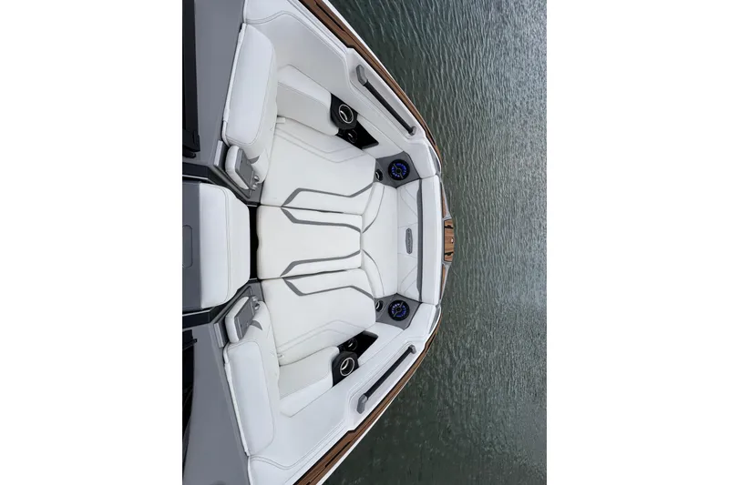 Slide: The Image of 2023 Supra SE 550 boat interior with white seating on water. - 12