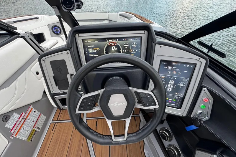 Slide: The Image of 2023 Supra SE 550 boat dashboard with advanced digital controls and steering wheel. - 15