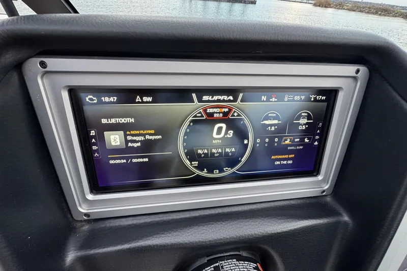 Slide: The Image of 2023 Supra SE 550 dashboard display showing Bluetooth music and navigation controls. - 16