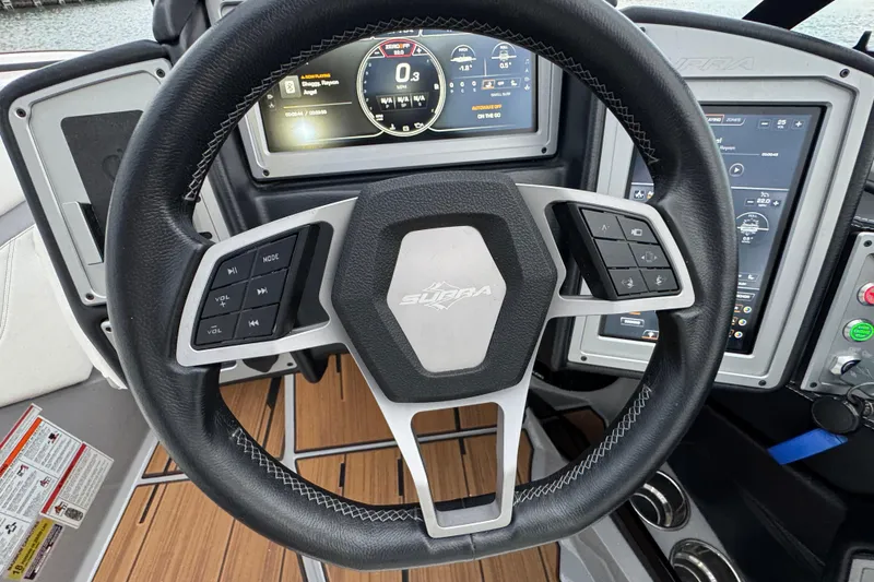 Slide: The Image of Steering wheel of 2023 Supra SE 550 boat with digital dashboard controls. - 18